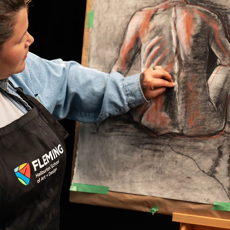 a young woman sketches the human form