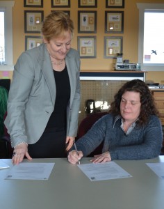 Dean Linda Skilton and Val Deziel of Nature Conservancy of Canada sign the MOU.