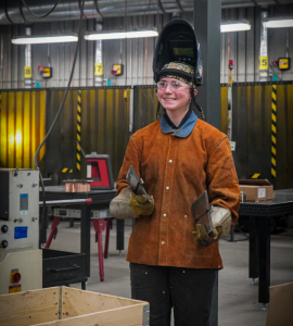A student proudly smiling for the camera